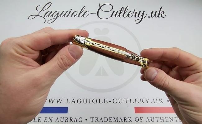 Laguiole corkscrew knife with brass bolsters and a red heart wood handle