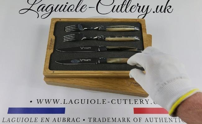 Two Laguiole steak knives and two forks with zebu horn tip handles